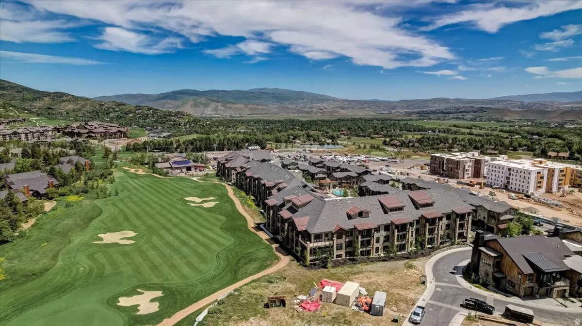 Aerial view of a mountainous background and a golf course