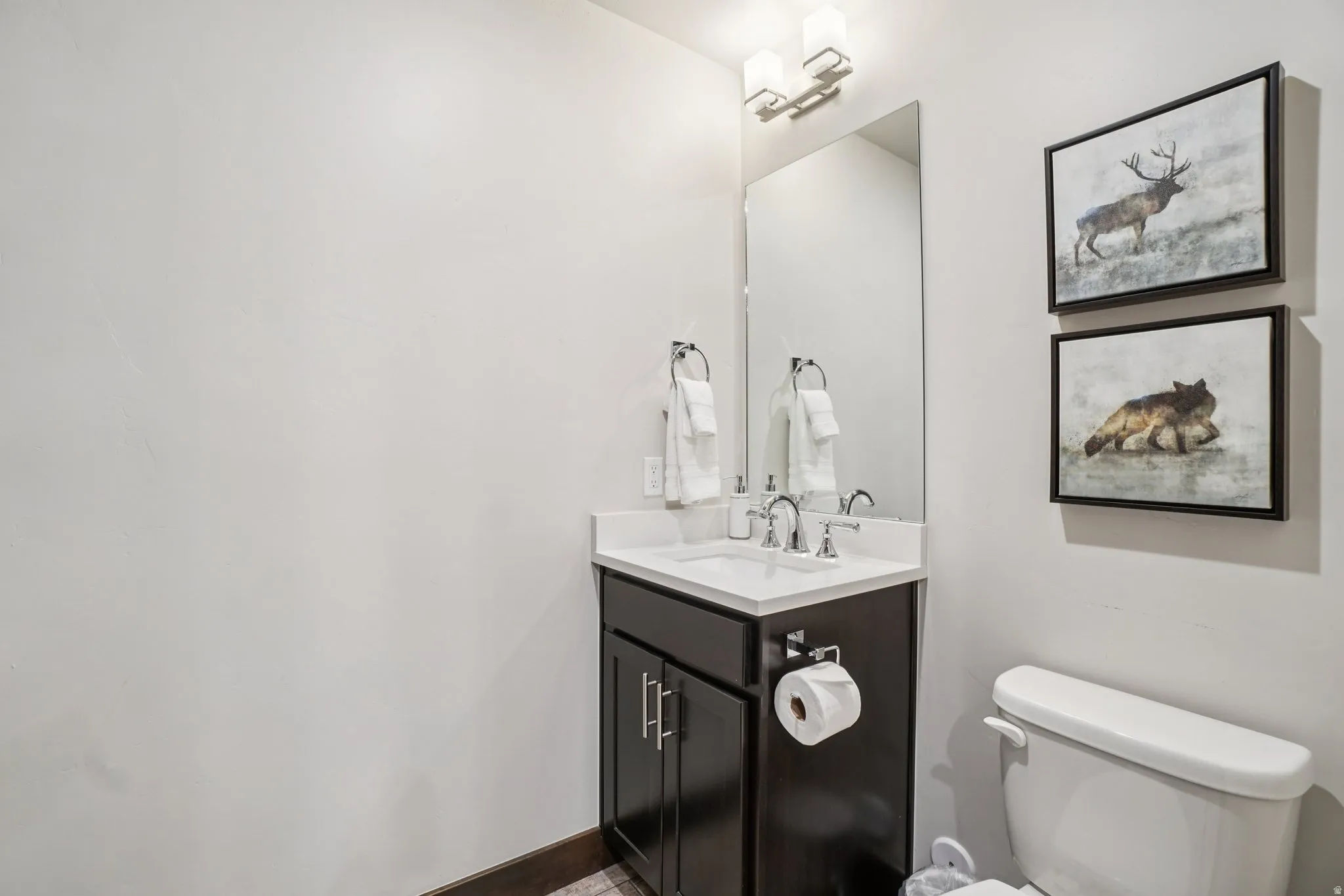 Half bath featuring vanity and toilet