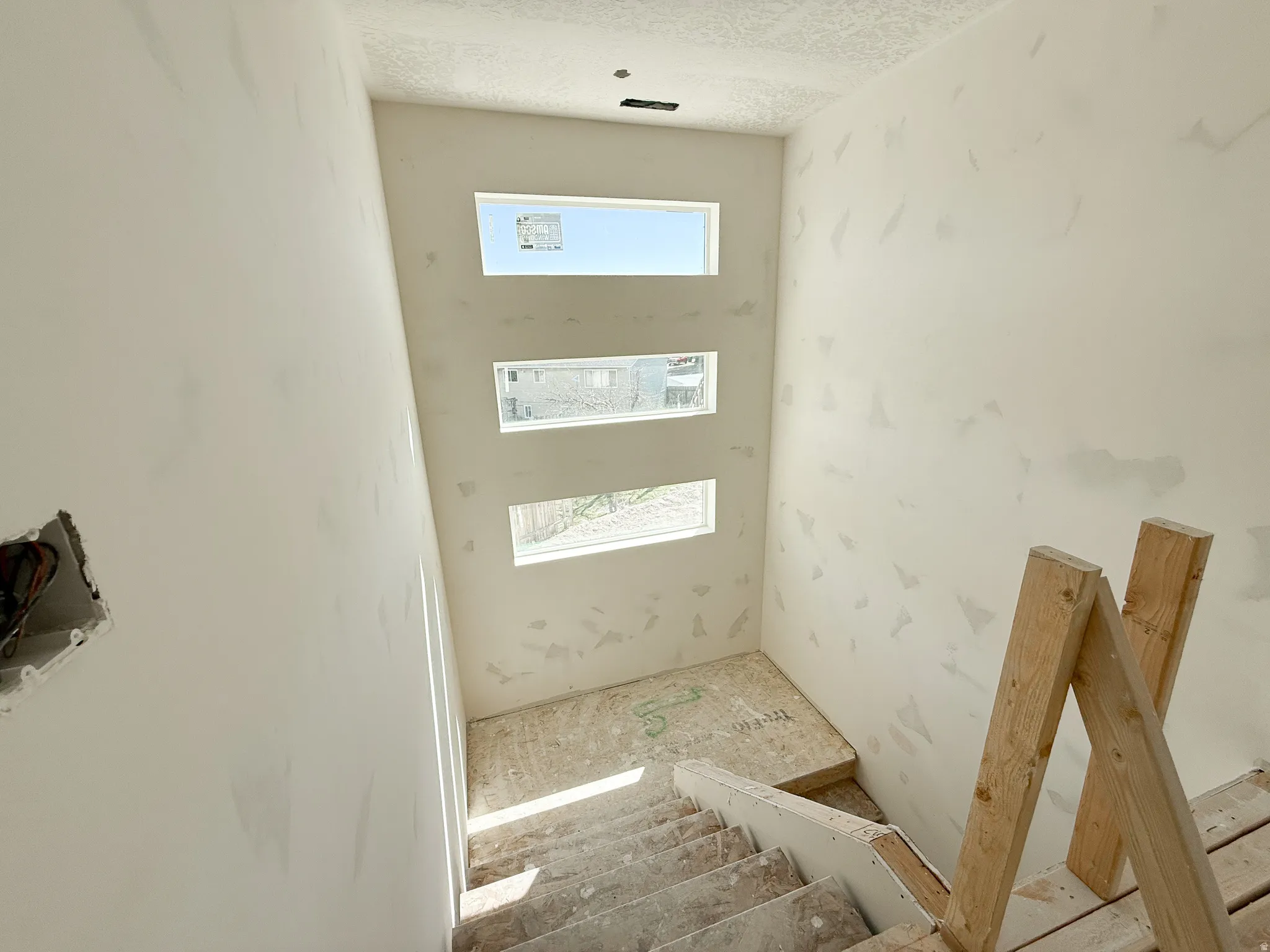 Staircase with a textured ceiling