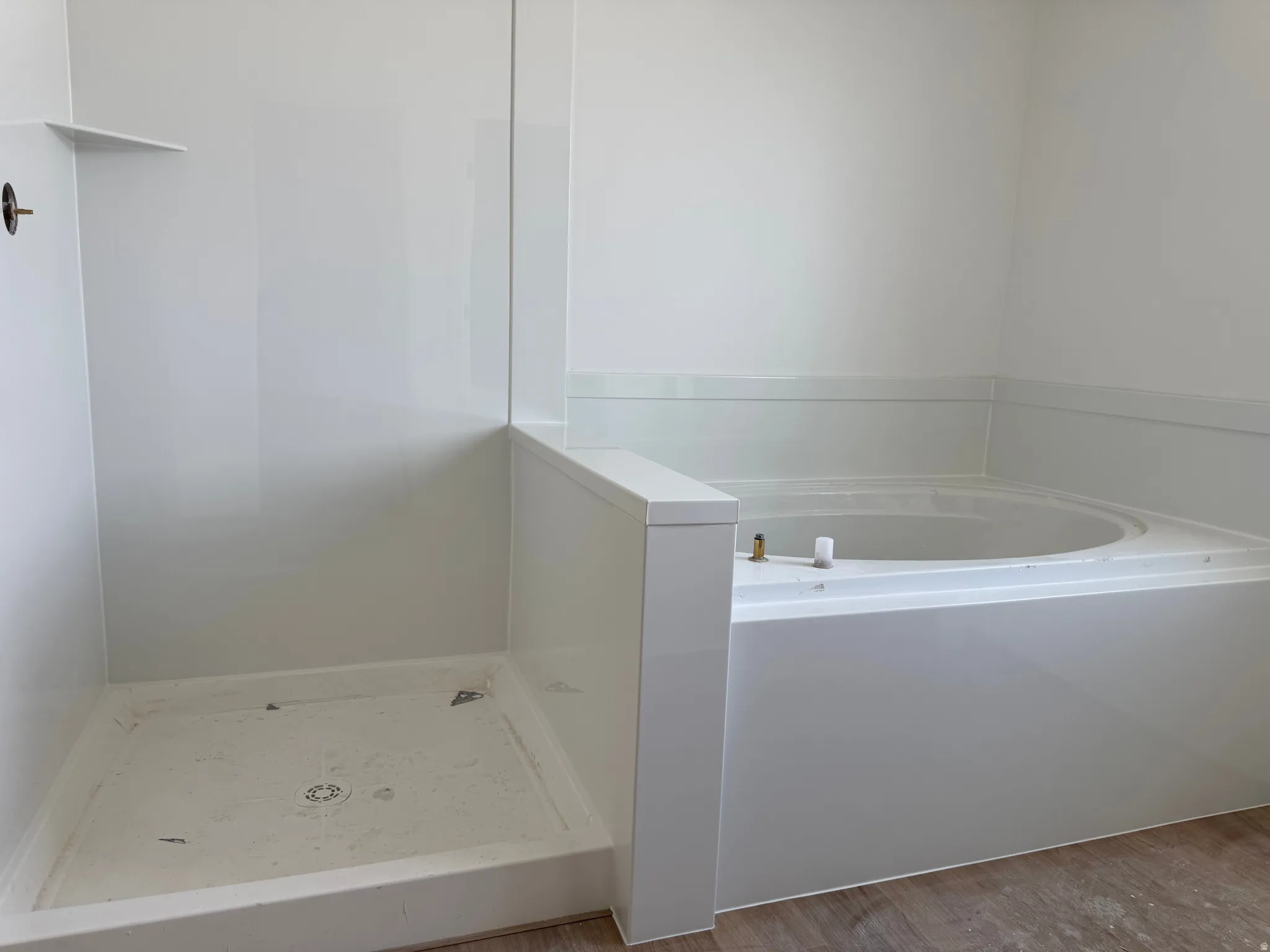 Full bath featuring a garden tub and wood finished floors