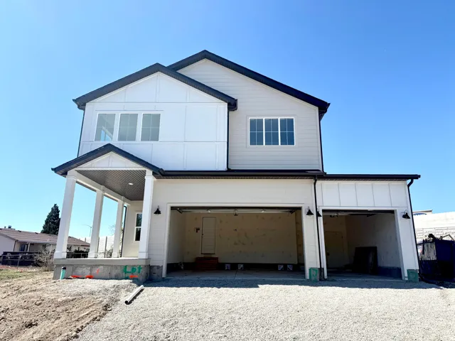 View of front of property with driveway, an attached garage, and board and batten siding