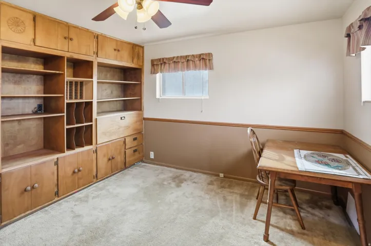 Home office featuring light colored carpet and ceiling fan