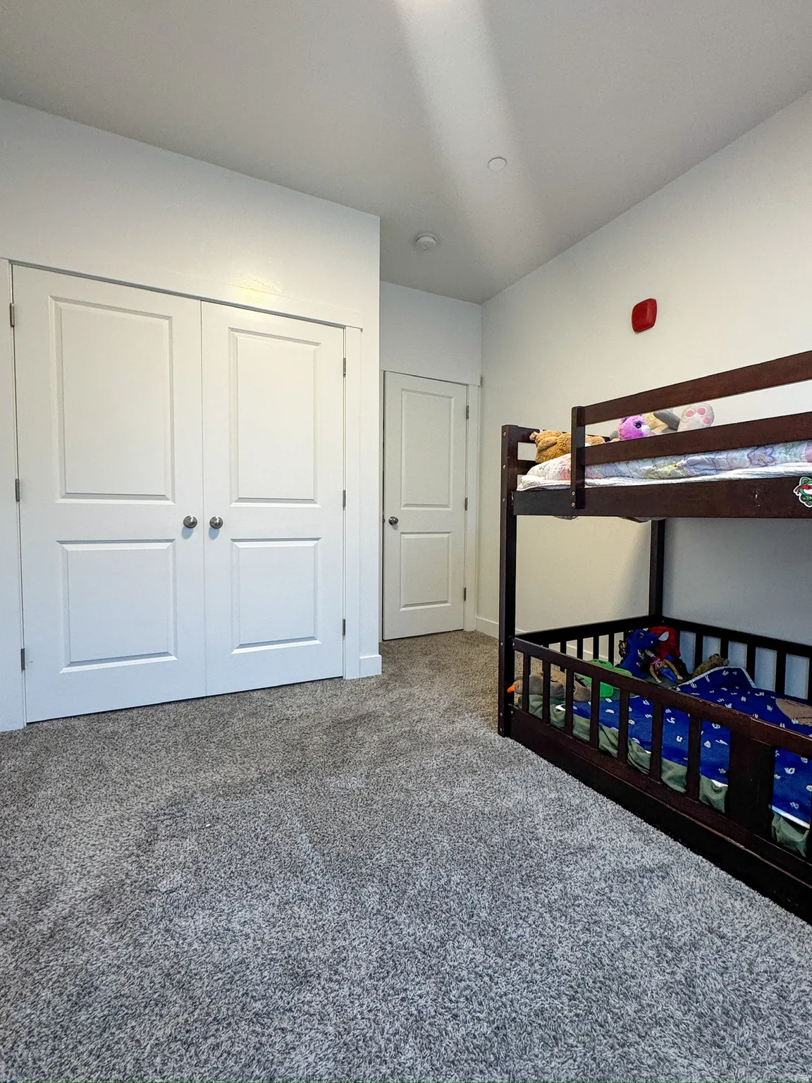 Unfurnished bedroom featuring a closet and dark colored carpet