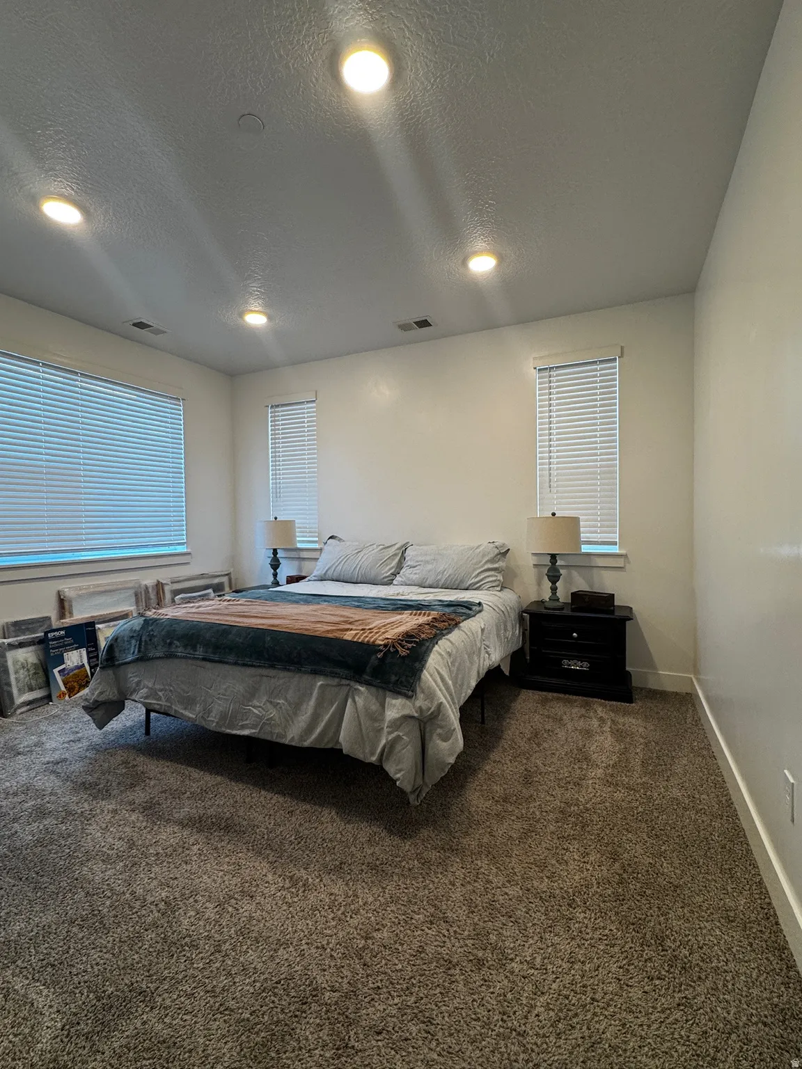 Bedroom with carpet flooring and a textured ceiling