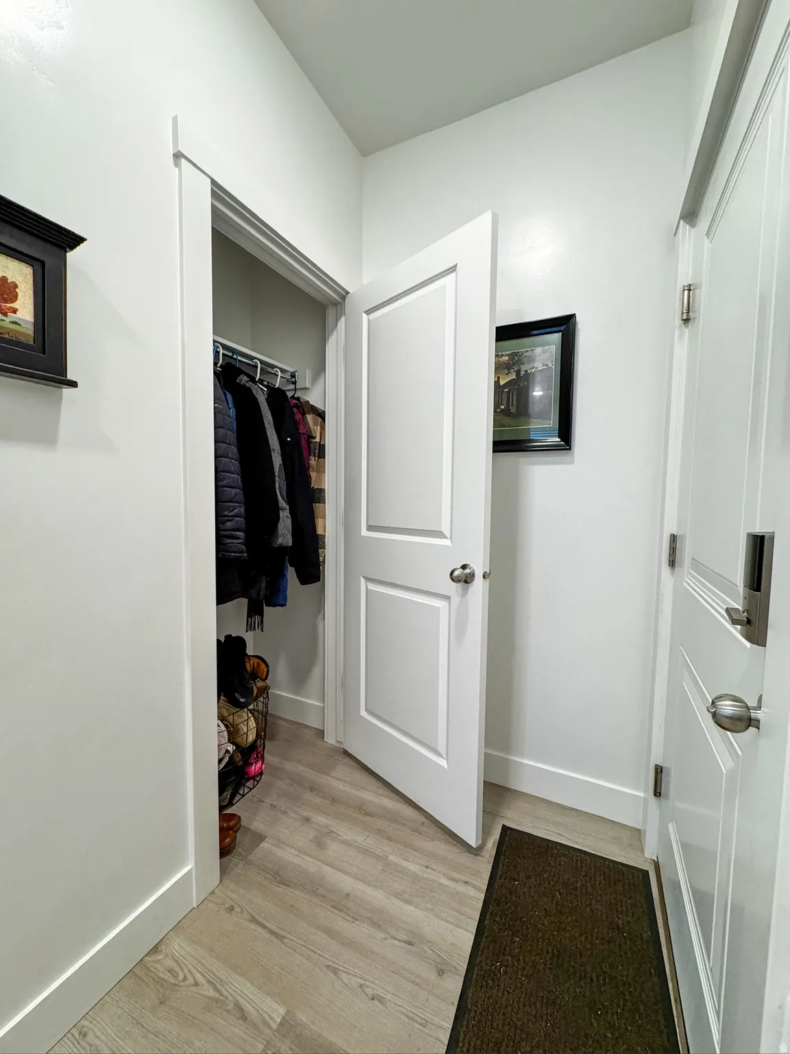 Interior space with baseboards and light wood-style flooring
