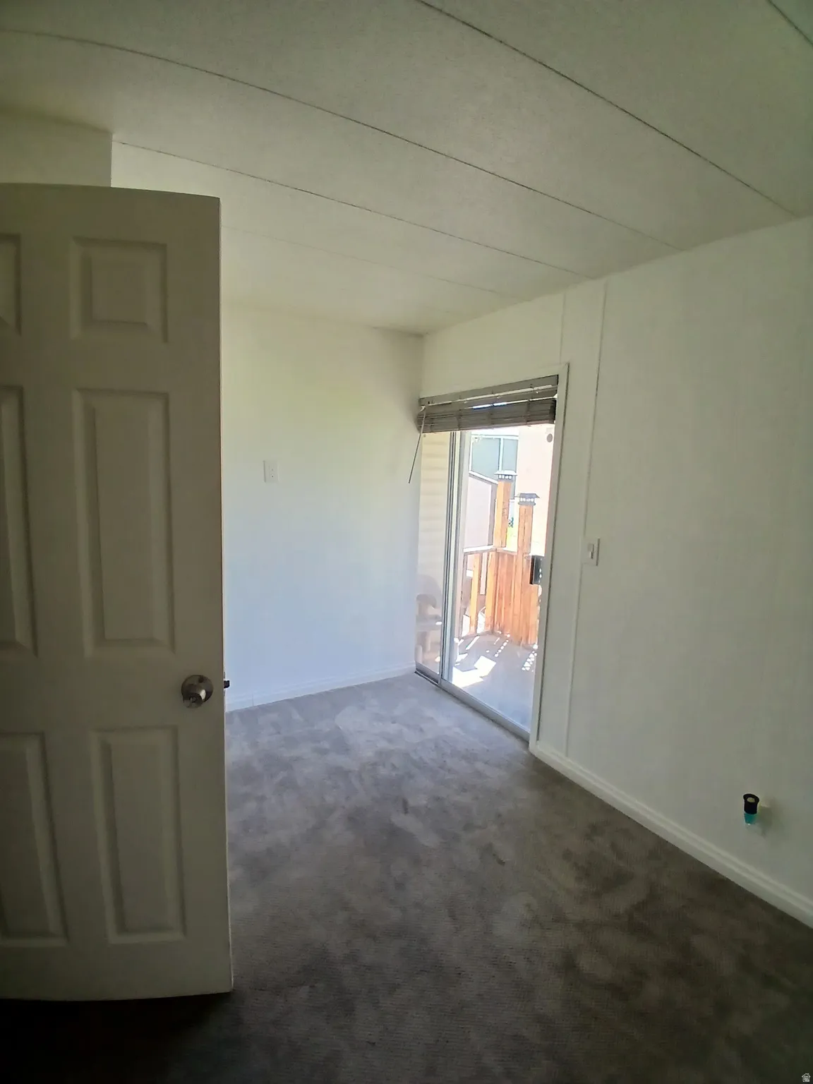 Carpeted spare room with baseboards