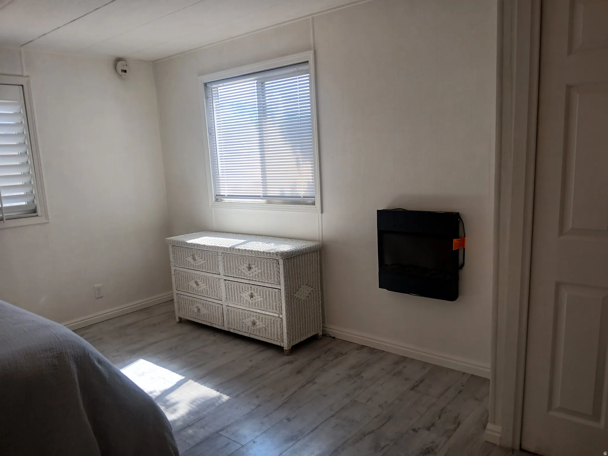 Bedroom featuring wood finished floors and baseboards