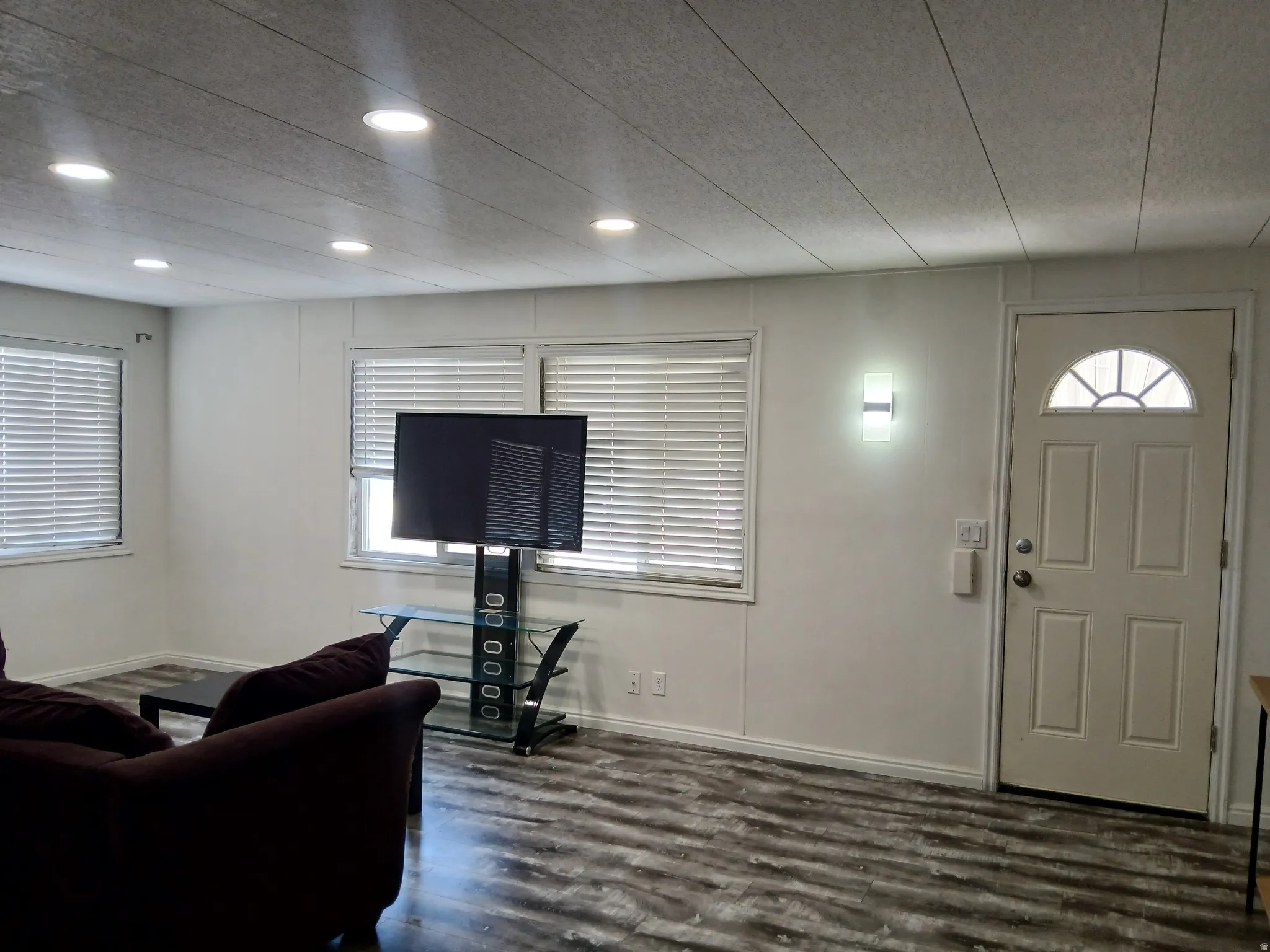 Foyer with dark wood-type flooring and recessed lighting