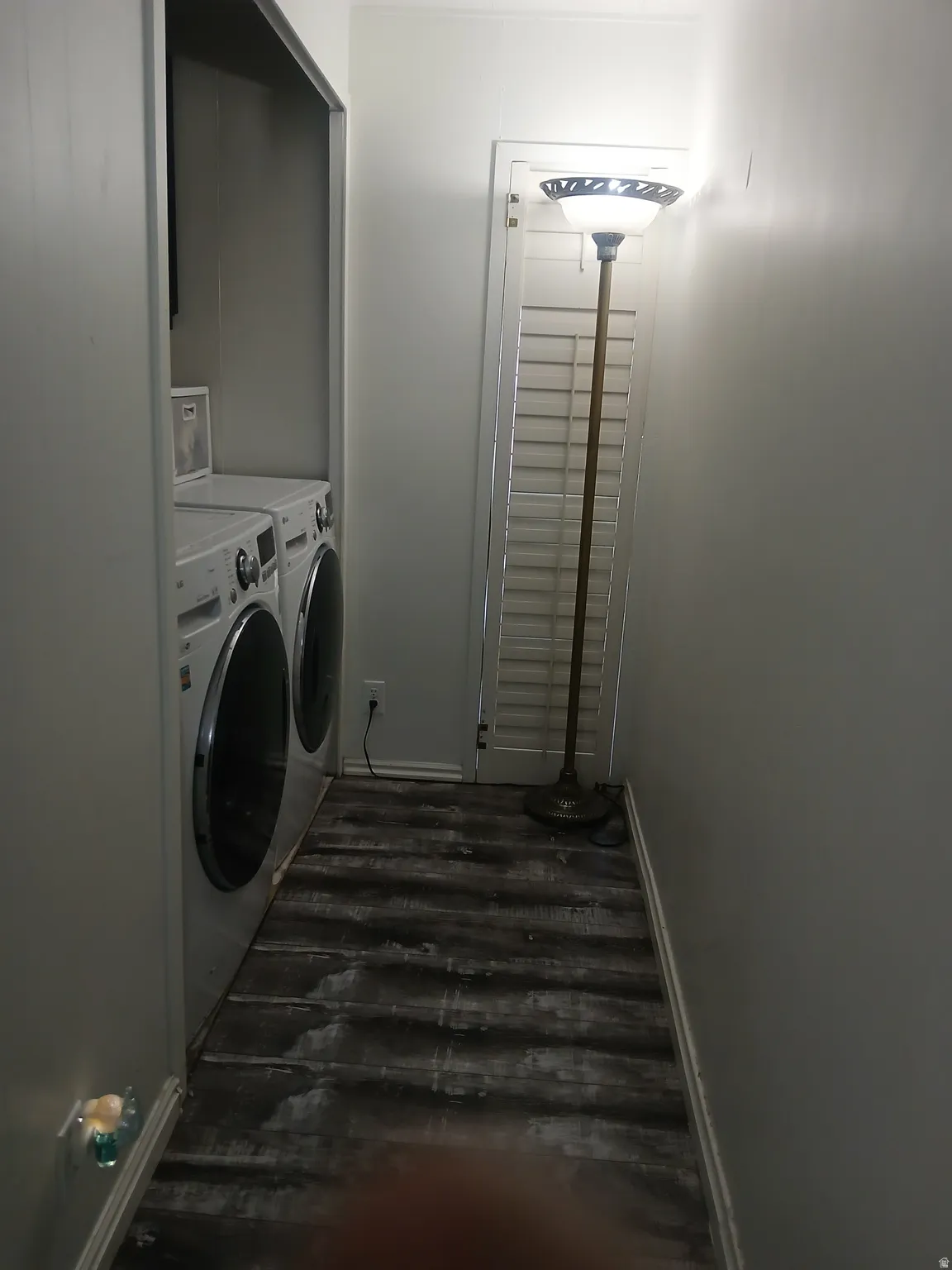 Laundry room featuring washer and dryer and dark wood-style flooring
