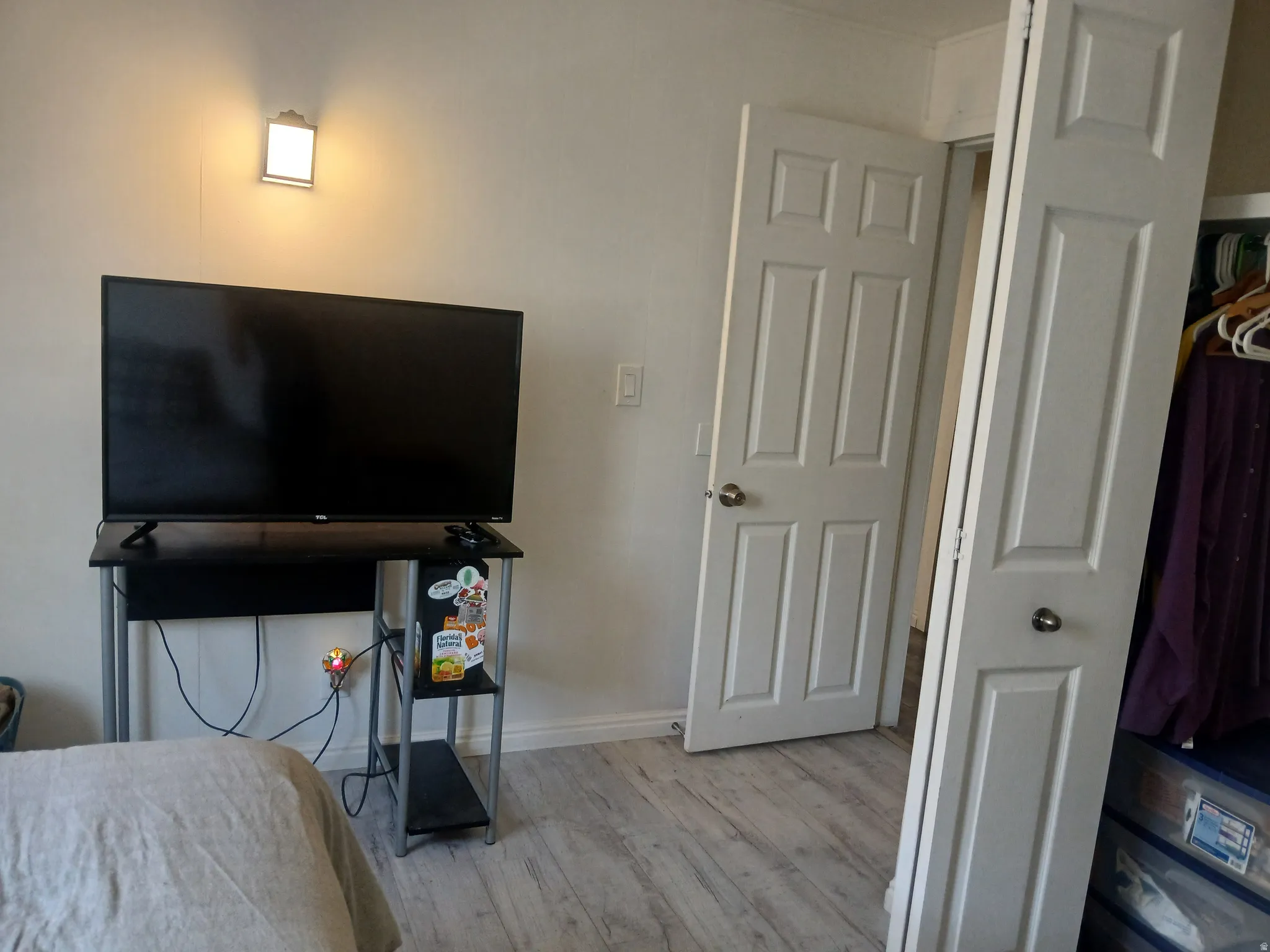 Bedroom featuring light wood-style floors and baseboards