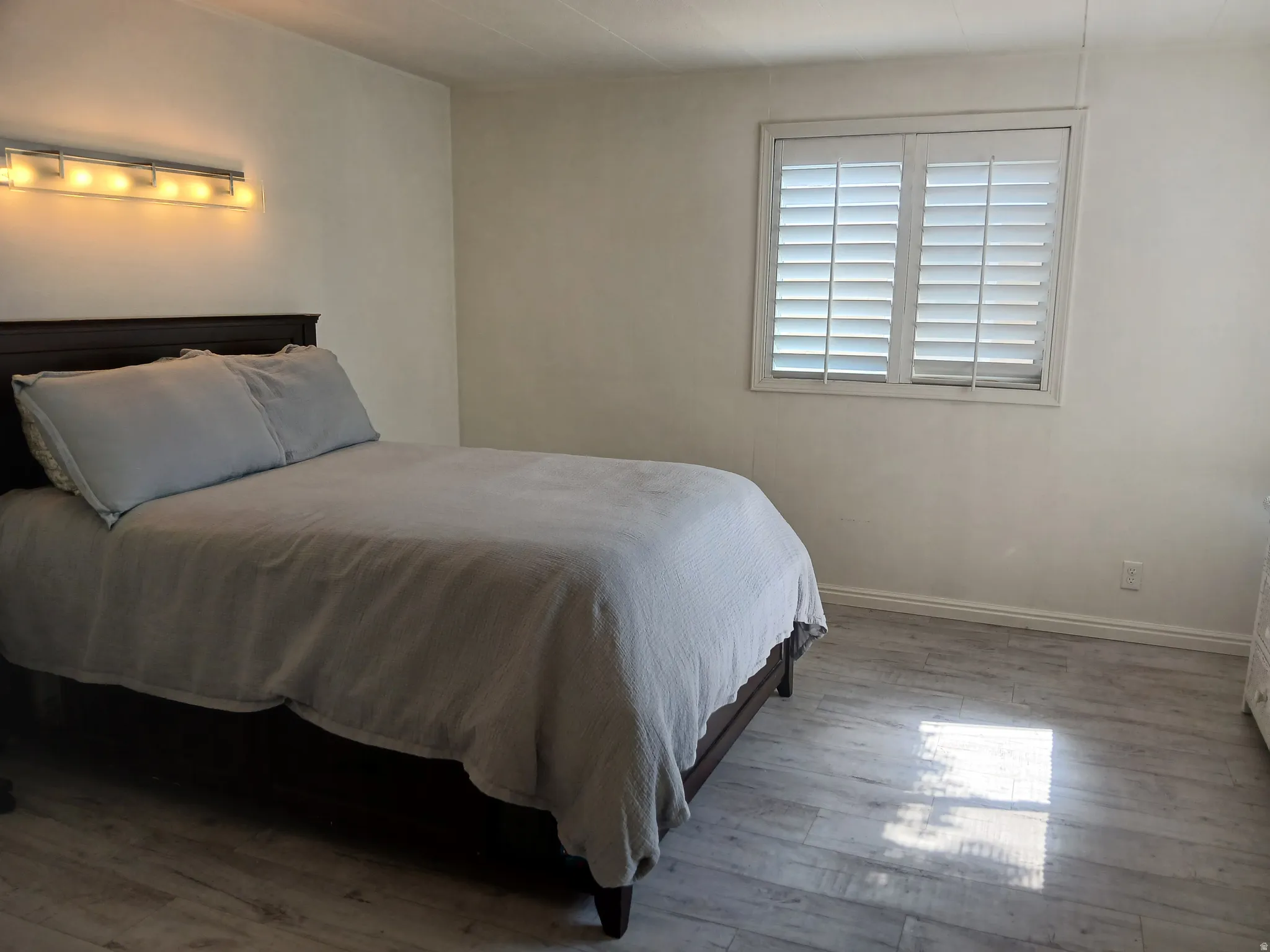 Bedroom featuring light wood-style flooring and baseboards