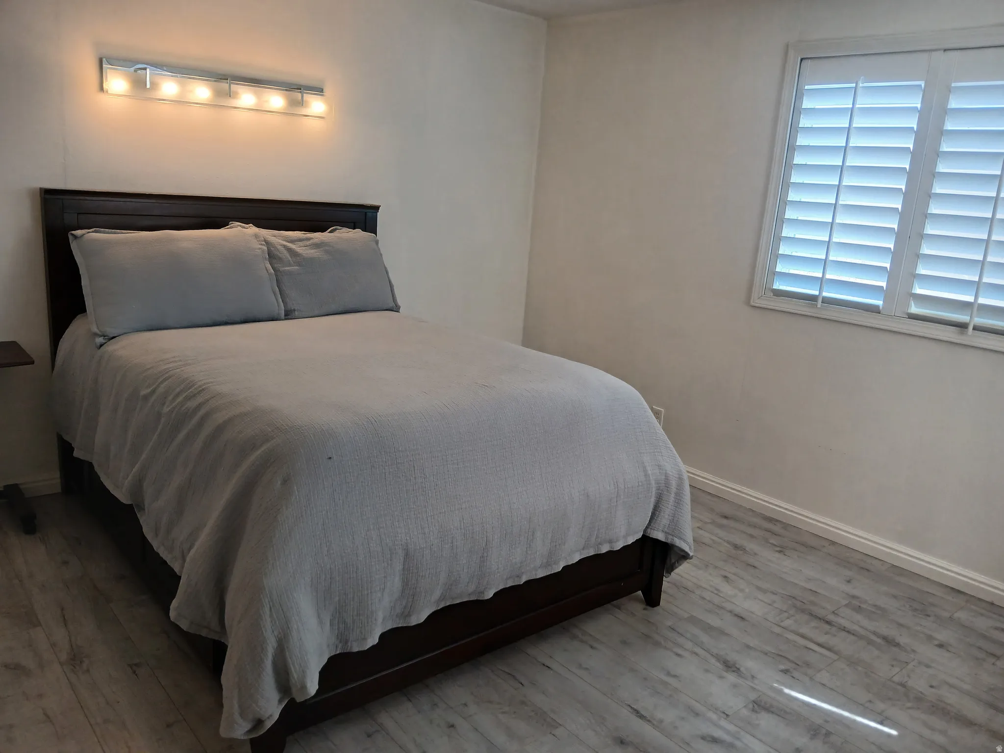 Bedroom with light wood-type flooring and baseboards