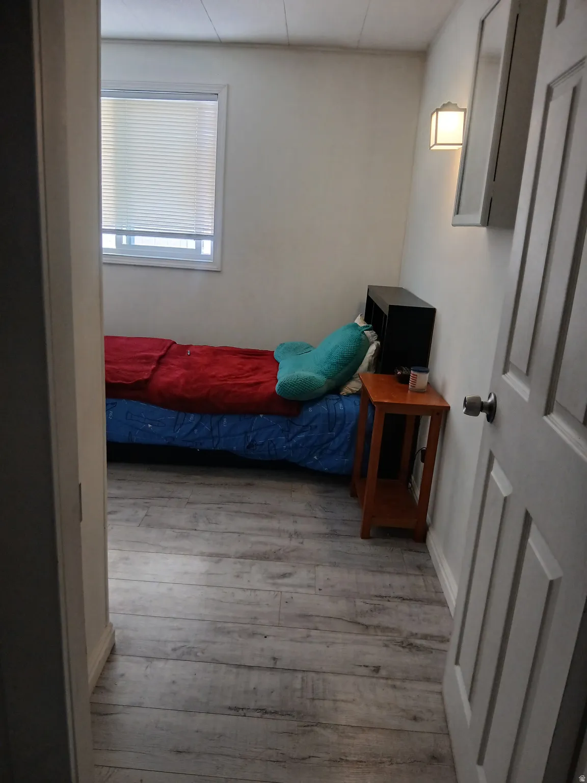 Bedroom featuring light wood finished floors and baseboards