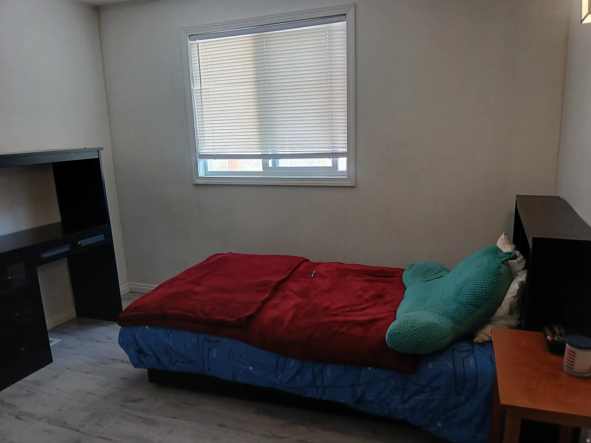 Bedroom featuring wood finished floors and baseboards