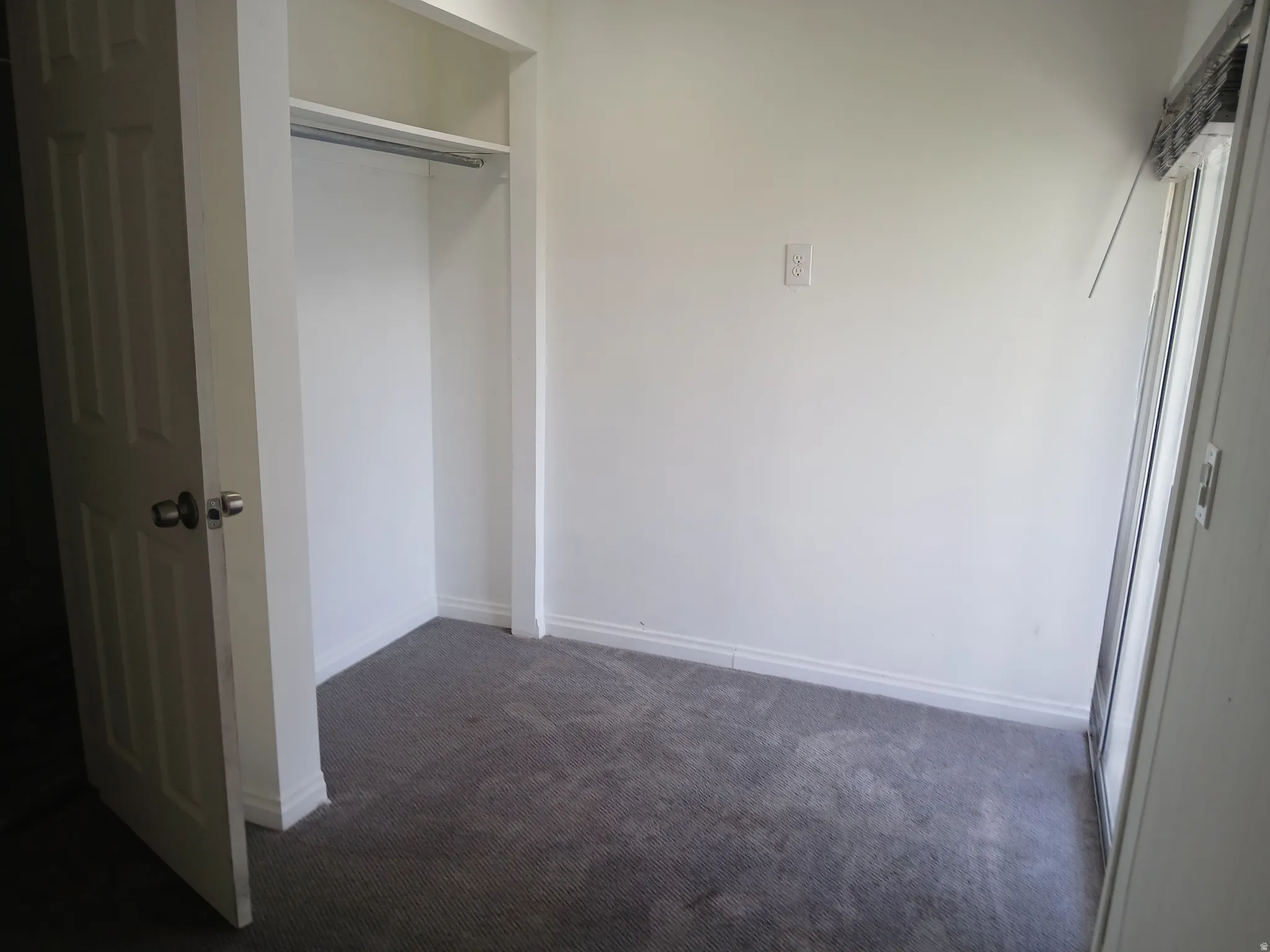 Unfurnished bedroom with a closet and carpet flooring