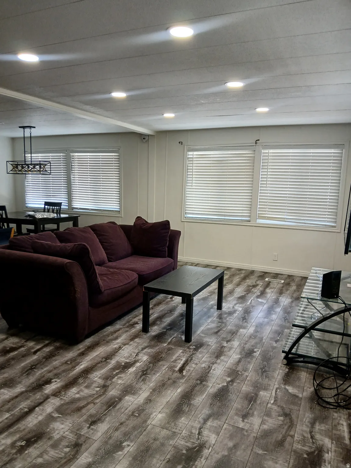 Living room featuring dark wood-type flooring and recessed lighting