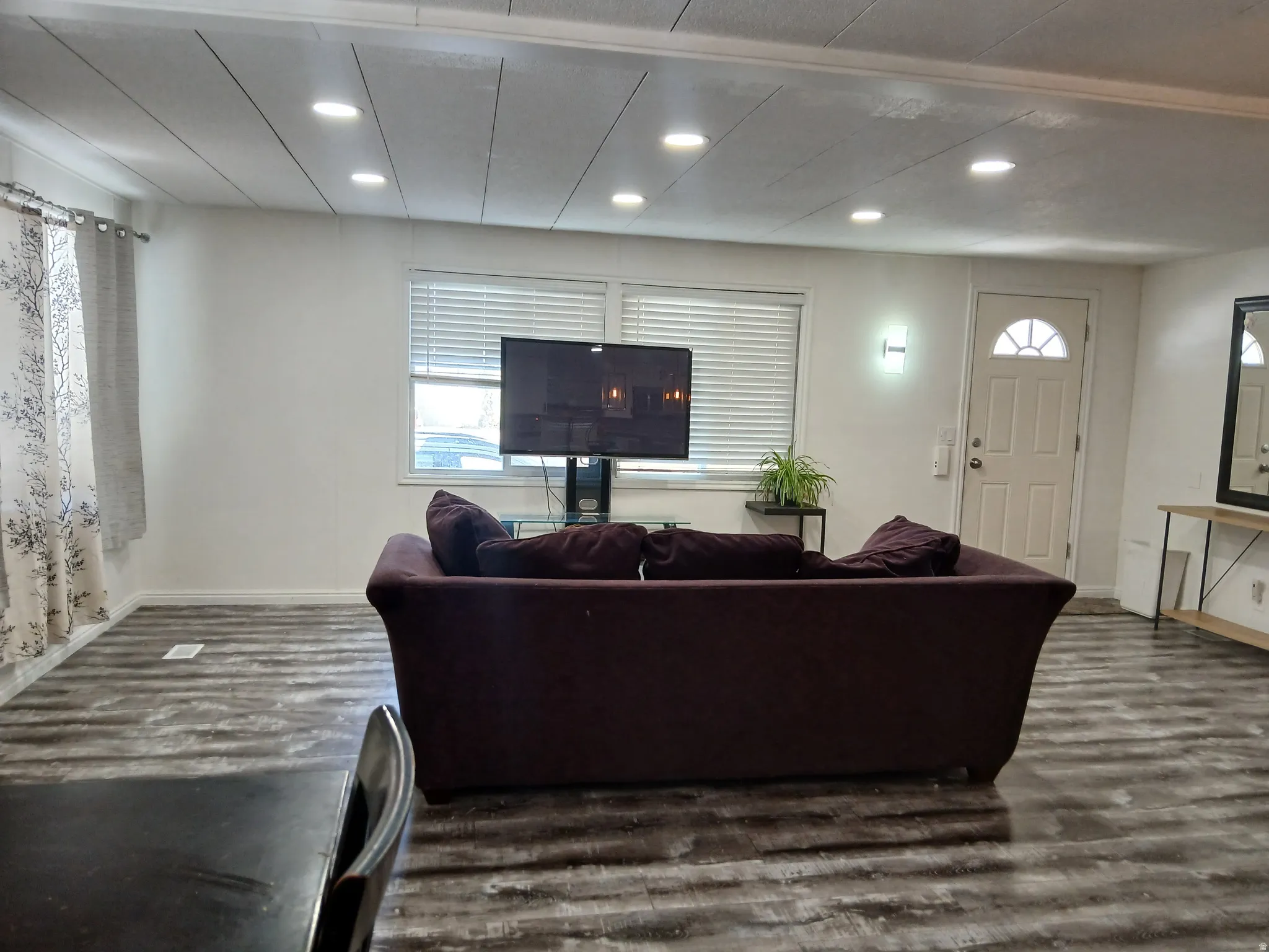 Living room featuring wood finished floors and recessed lighting