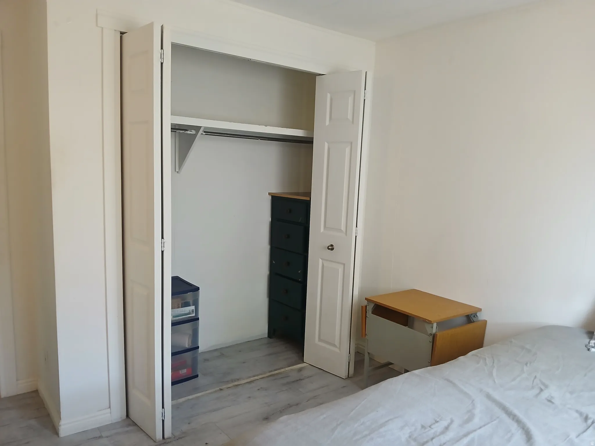 Bedroom with a closet and wood finished floors