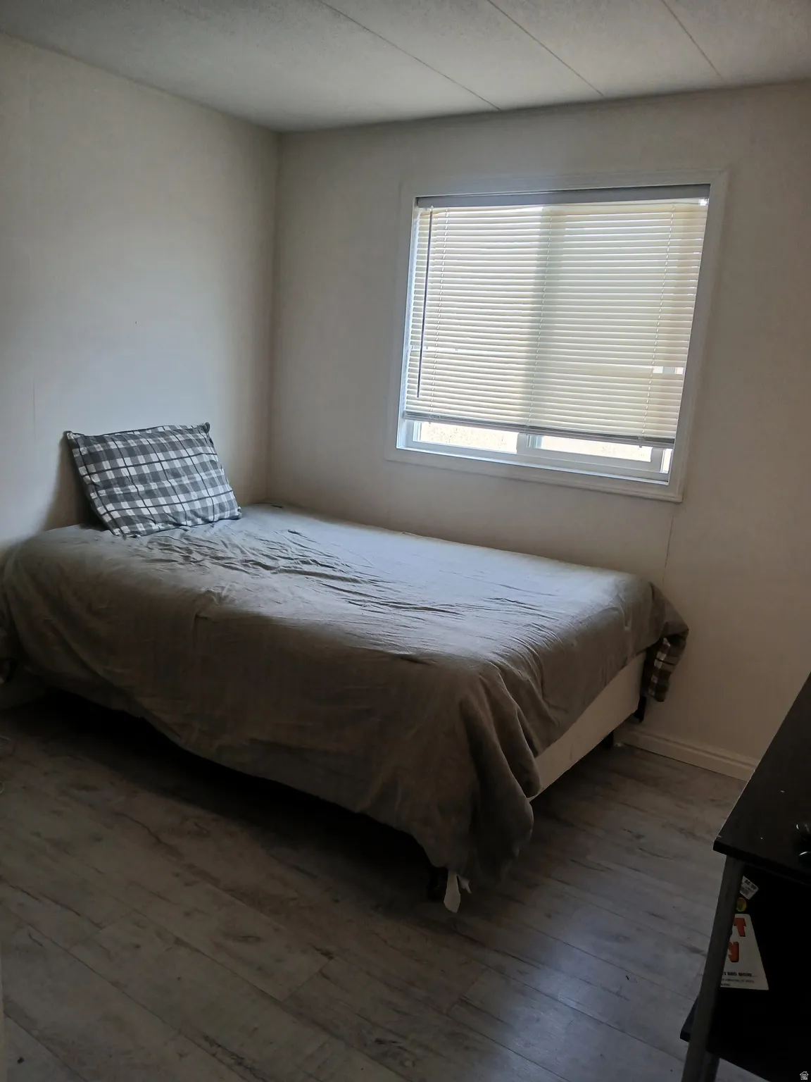 Bedroom with wood finished floors and baseboards