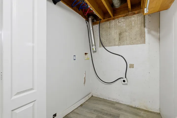 Laundry area with washer hookup and wood finished floors