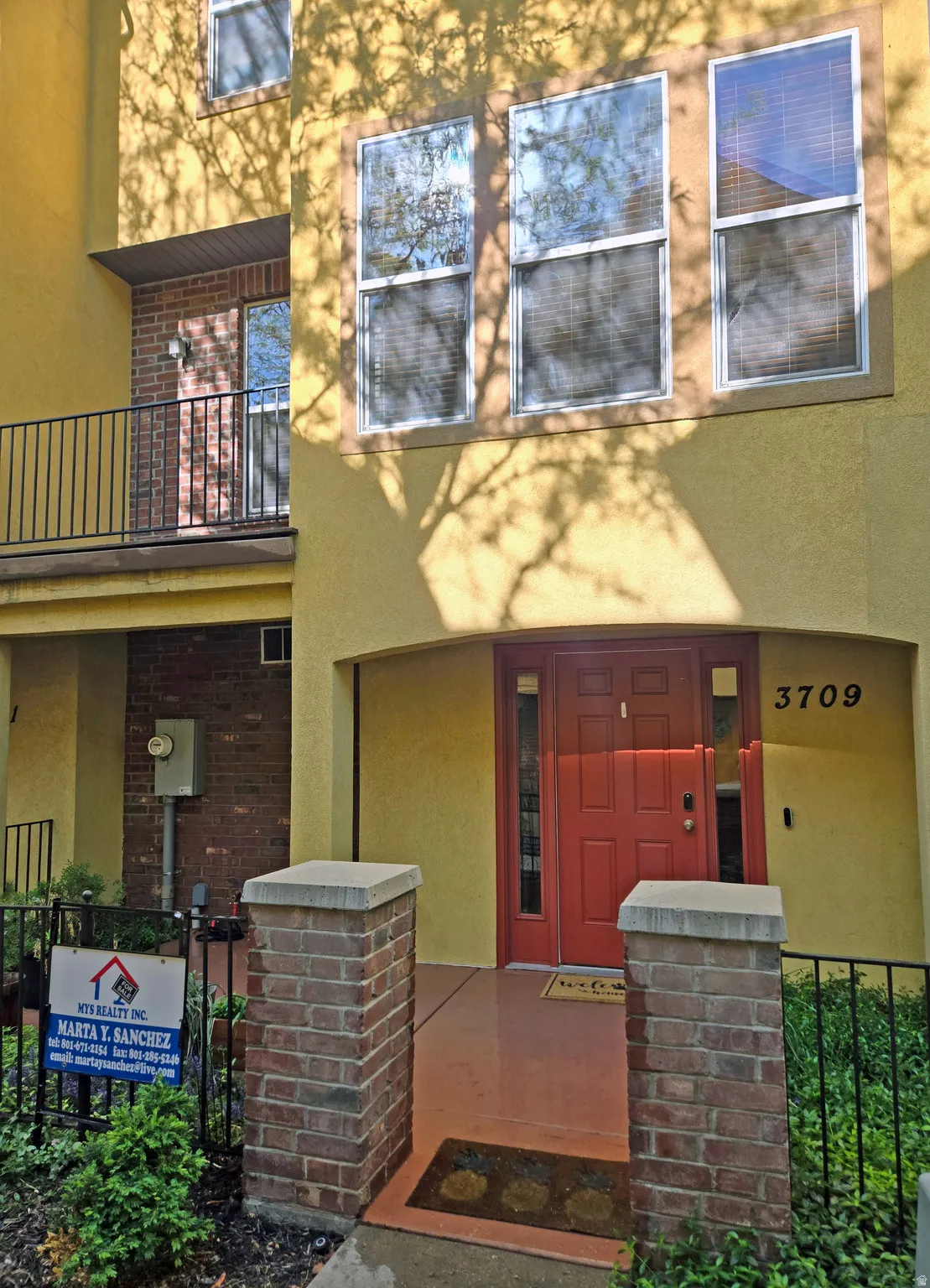 View of exterior entry with stucco siding and brick siding