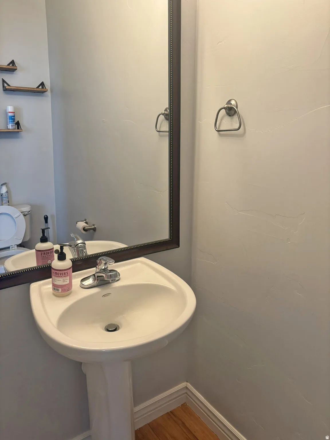 Bathroom with baseboards and wood finished floors
