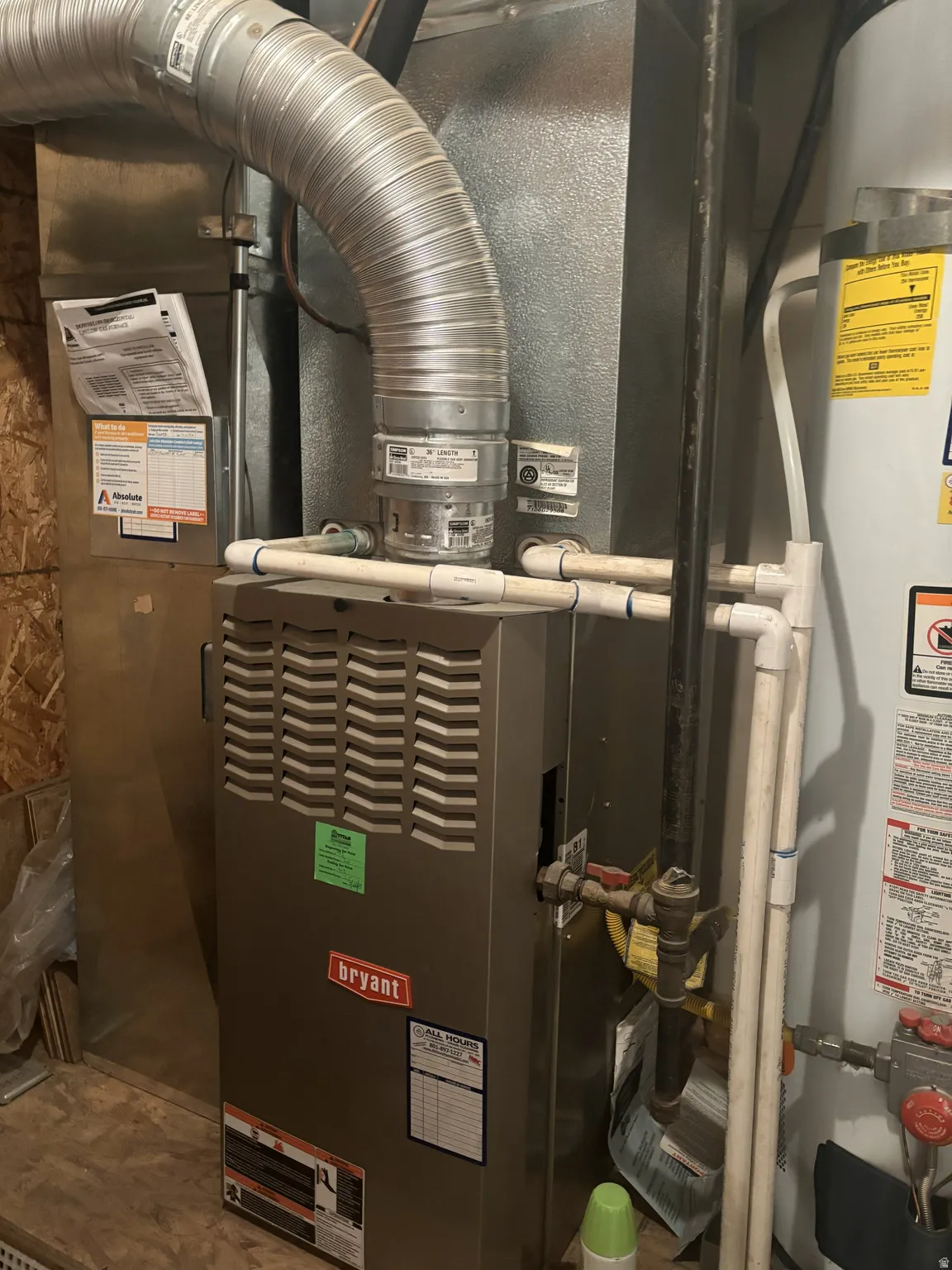 Utility room with heating unit and strapped water heater