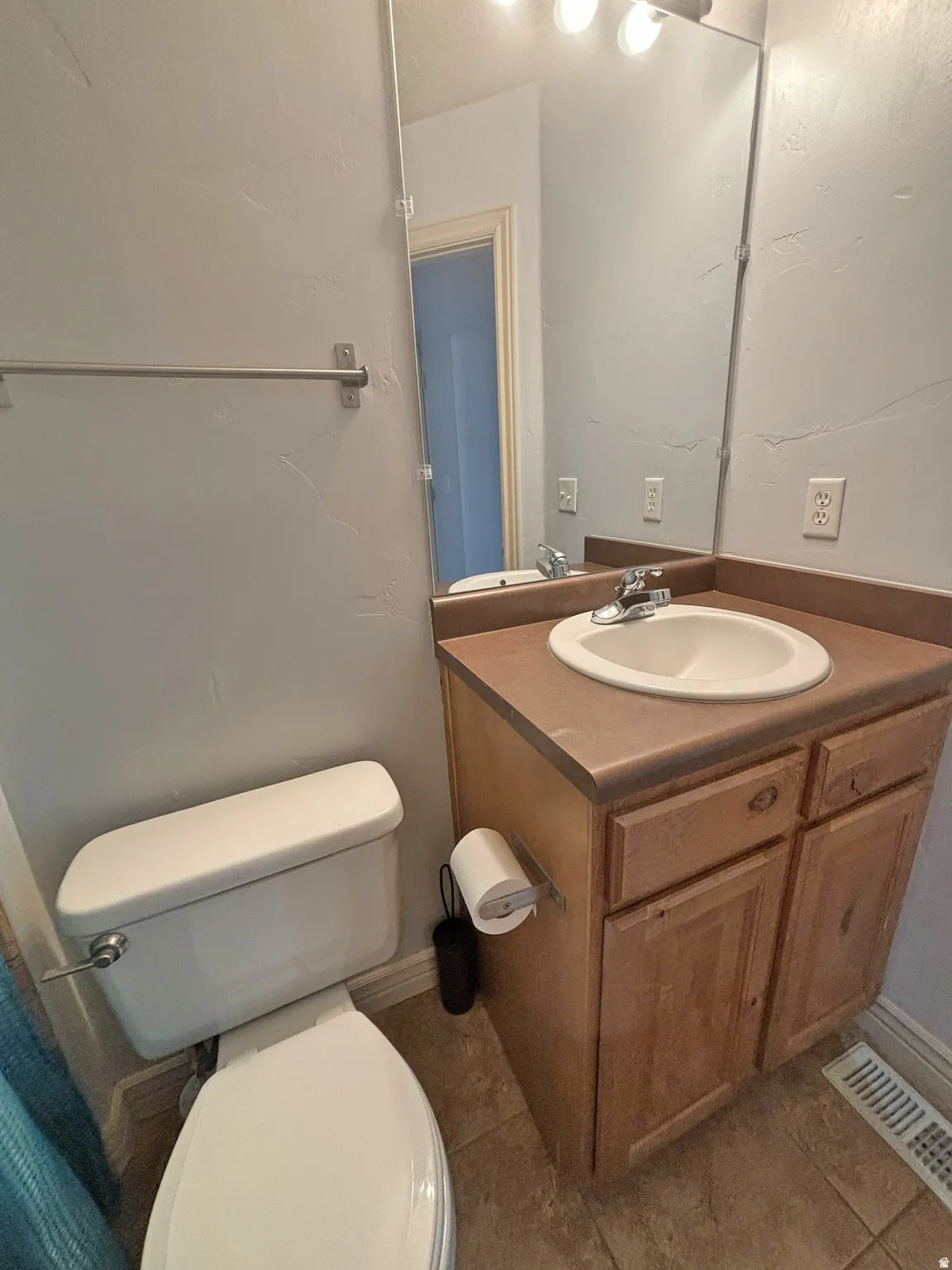 Bathroom with vanity and dark tile patterned flooring