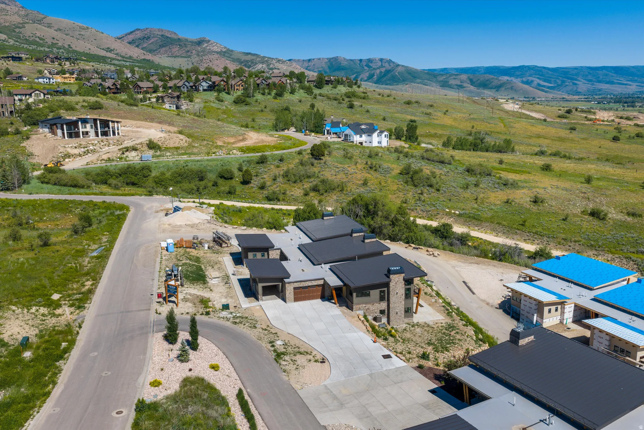 Contemporary residence featuring a multi-level roofline and stone and stucco exterior