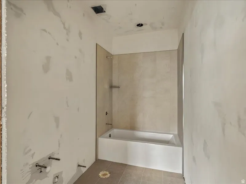 Full bathroom featuring shower / bath combination and tile patterned floors