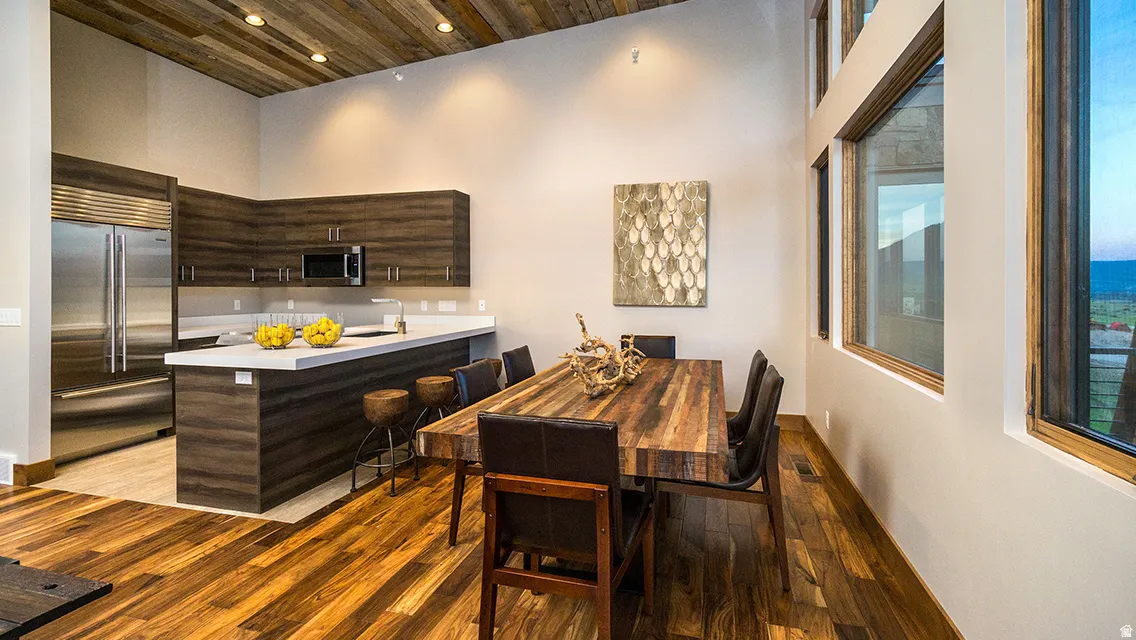 Dining space featuring light wood-style floors, recessed lighting, and wooden ceiling