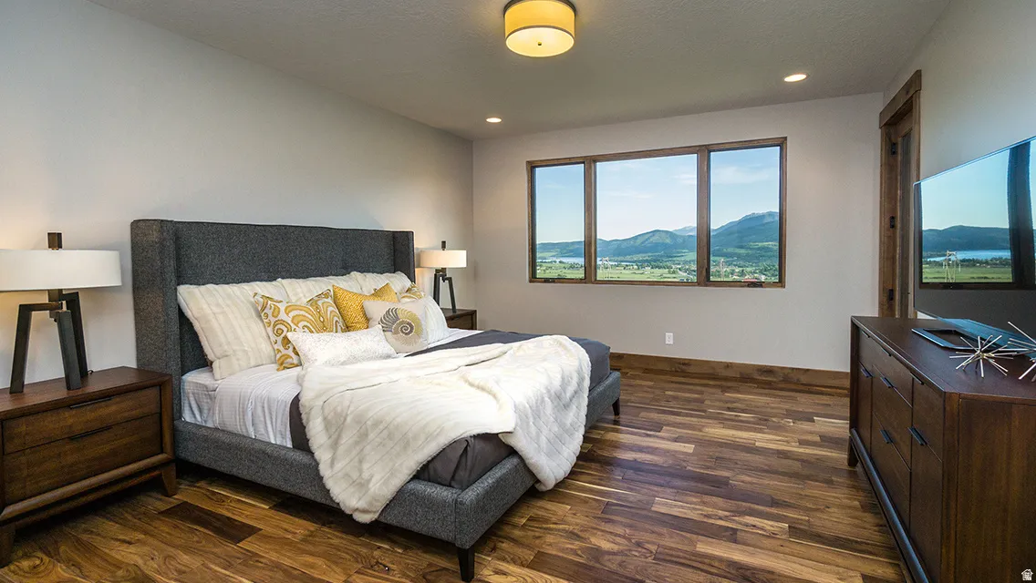 Bedroom with dark wood-style flooring and recessed lighting