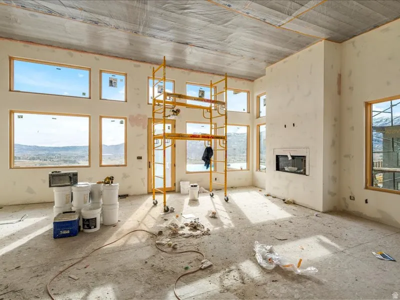 Unfurnished living room with a glass covered fireplace
