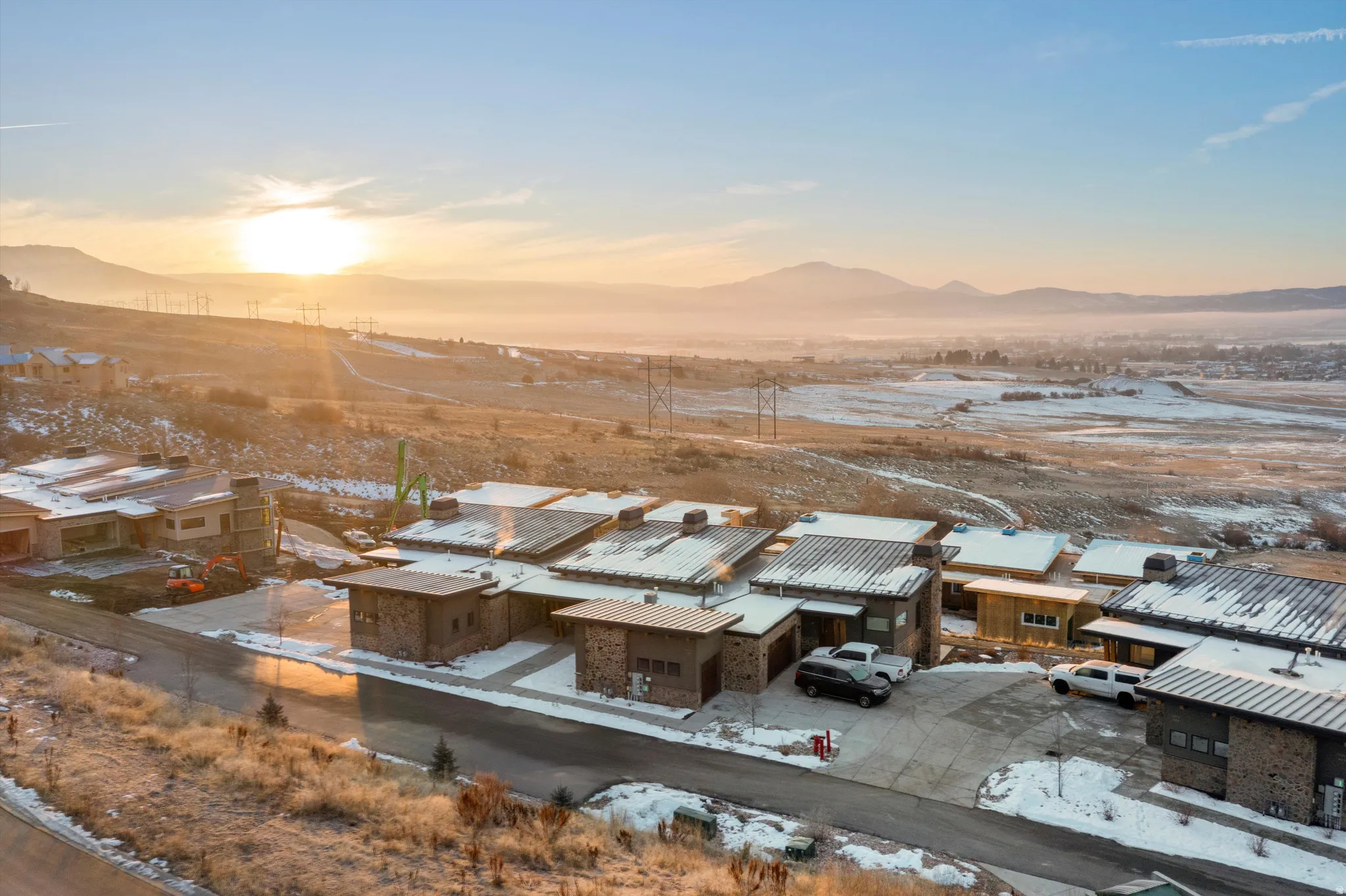 Snowy aerial view featuring a residential view and a mountain view