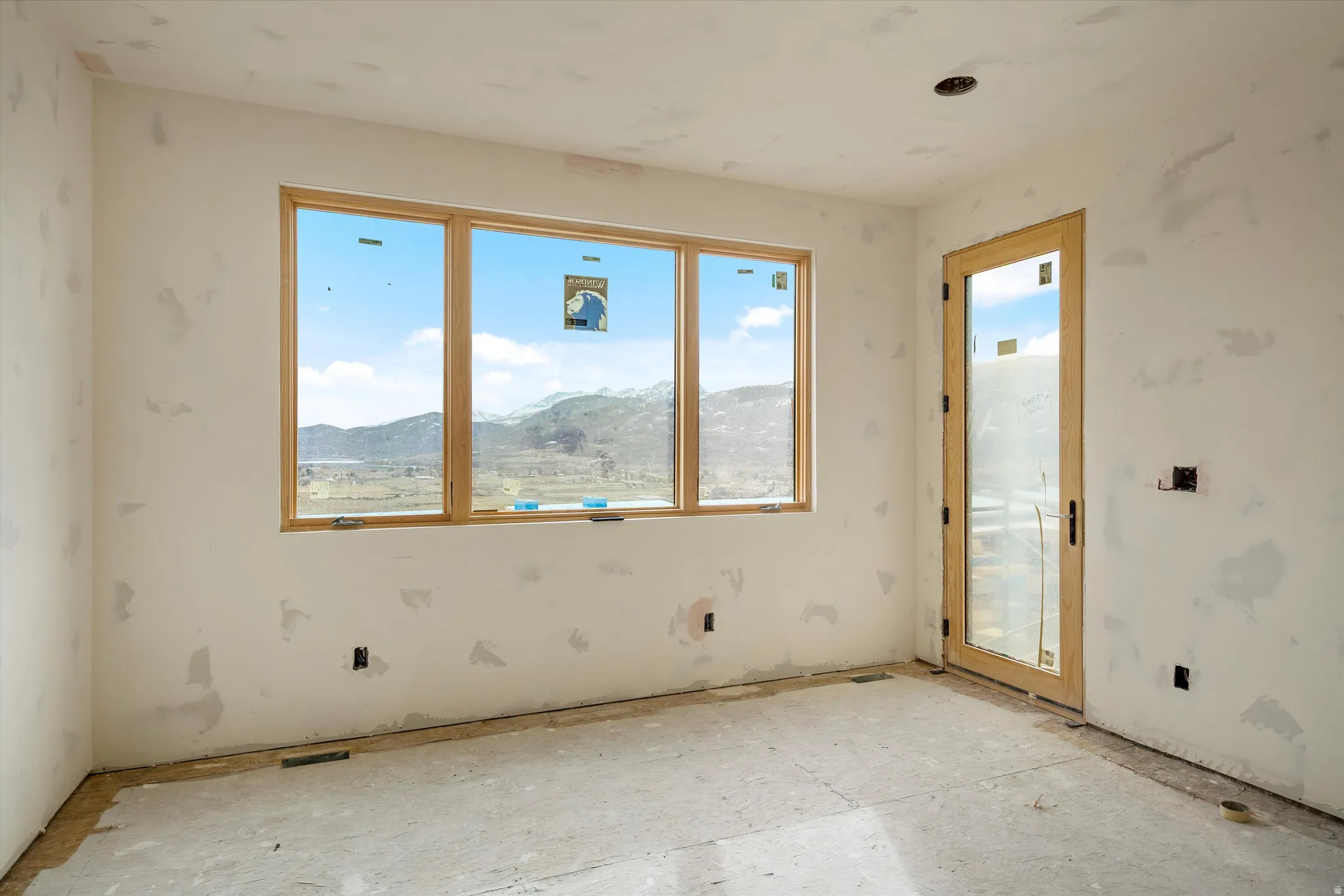 Large window framing a mountain and valley landscape