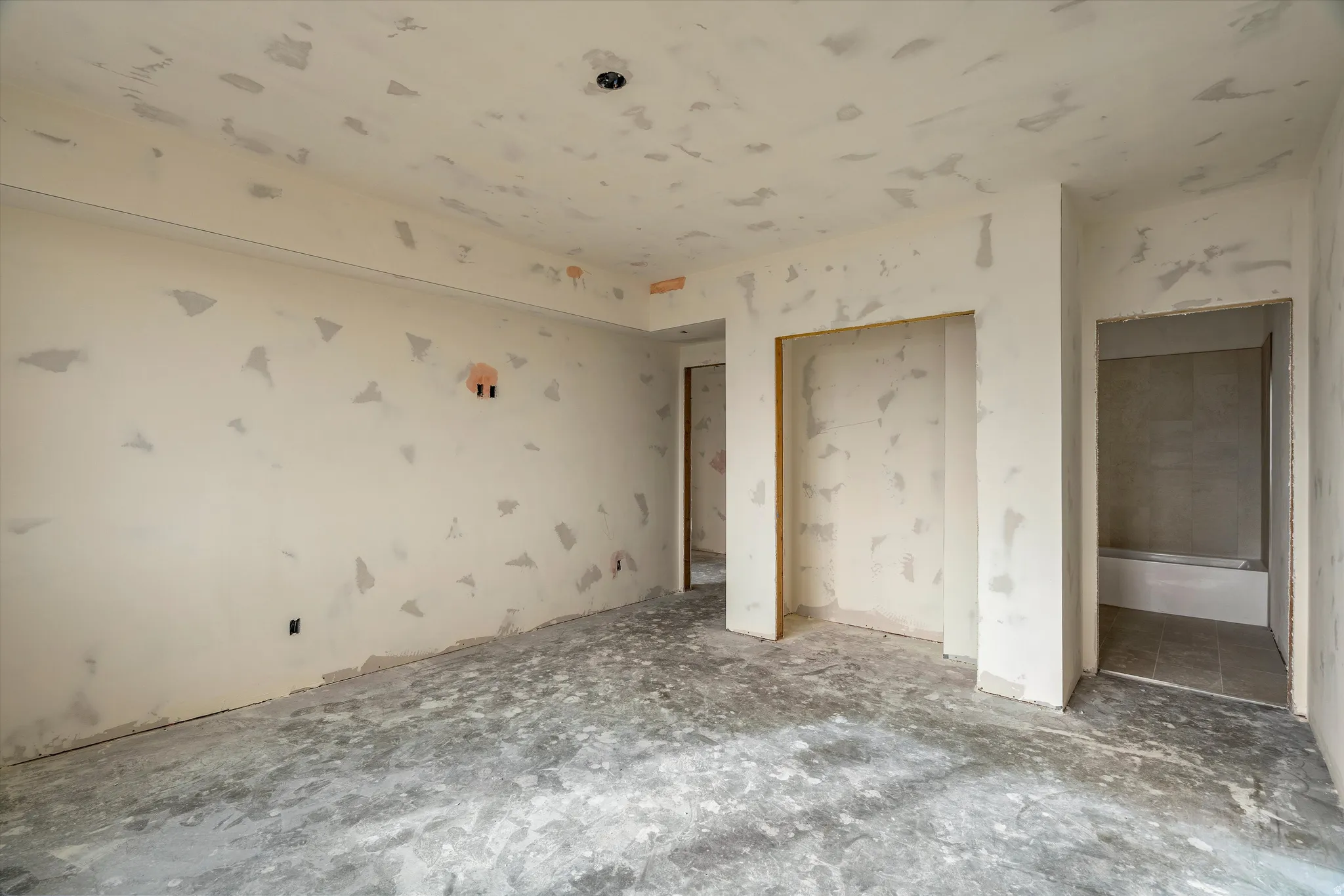 Unfinished interior space with smooth drywall-finished walls and ceiling