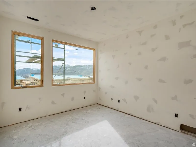 Spare room featuring plenty of natural light and a mountain view