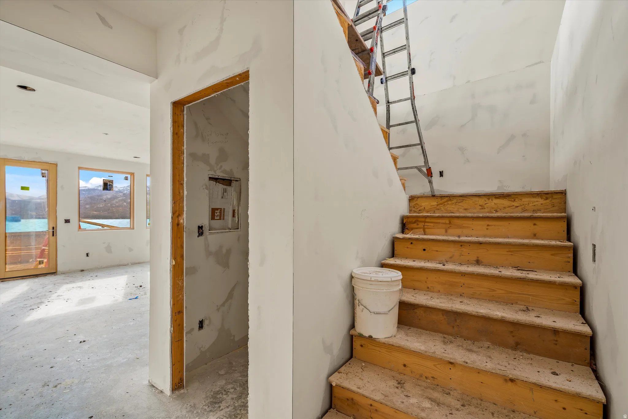 Unfinished wood staircase with drywall-ready walls