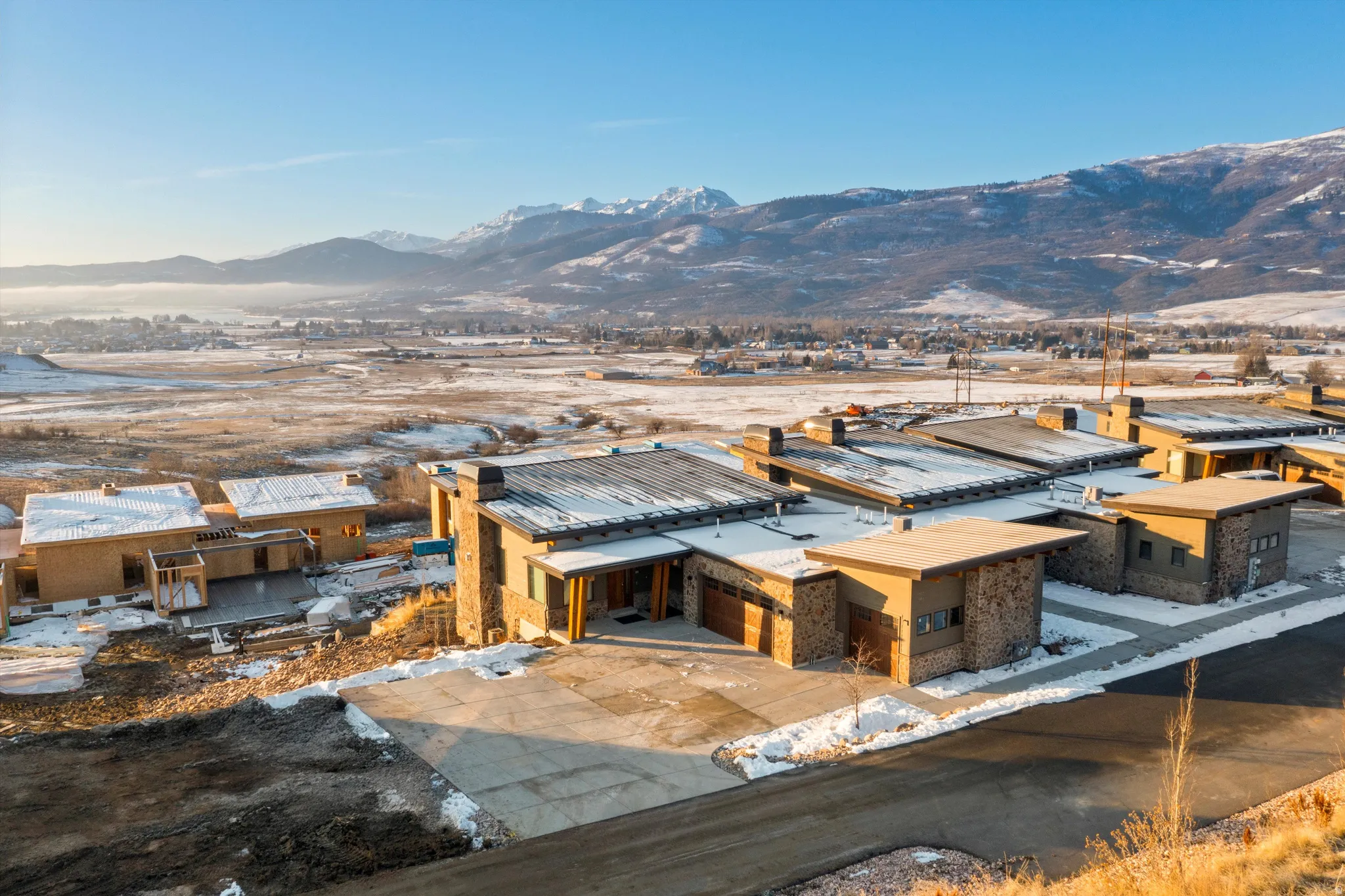 View of front of house with a mountain view and a patio area