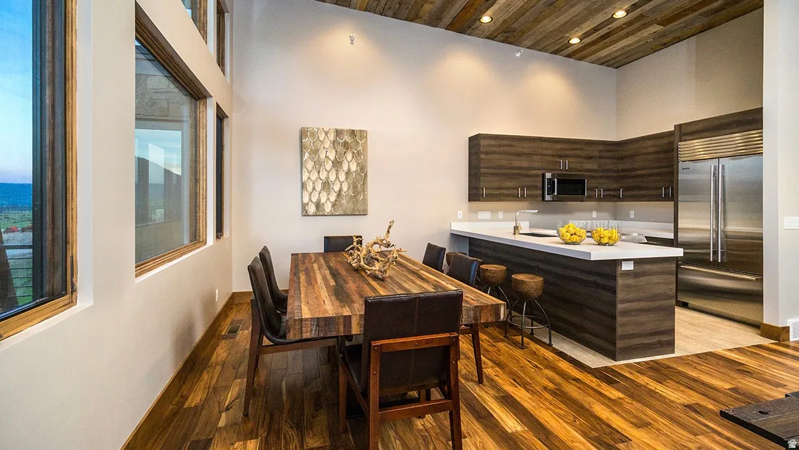 Dining space with light wood-type flooring, wooden ceiling, and recessed lighting