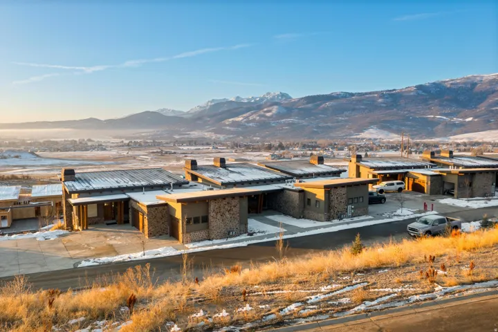 Back of property with a mountain view and brick siding