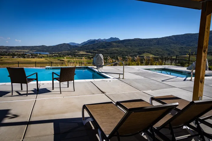 View of swimming pool with a patio area and a mountain view