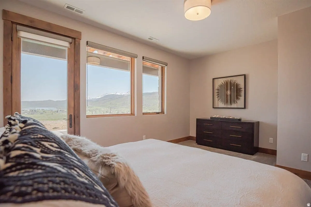 Bedroom with access to exterior and a mountain view