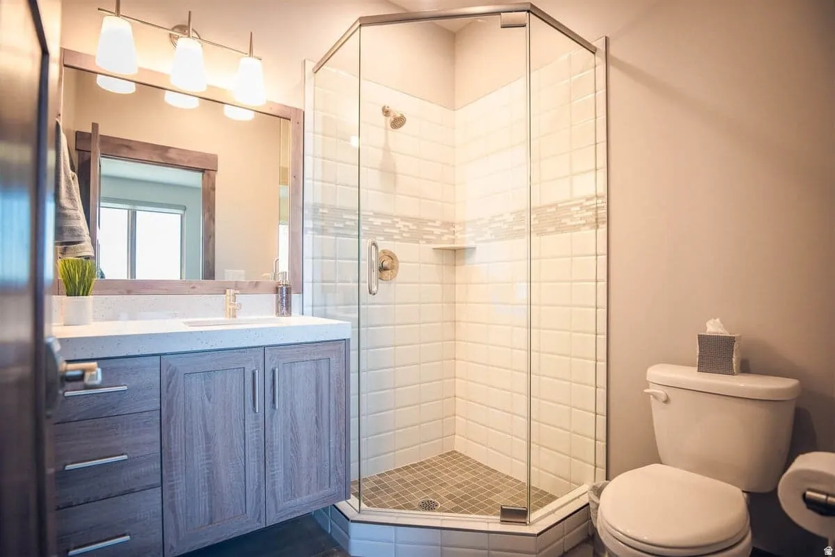 Bathroom featuring a shower stall and vanity