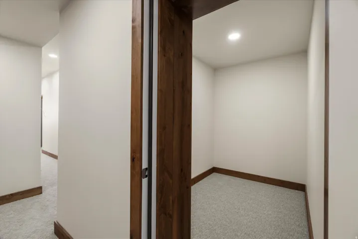 Interior space featuring light-toned walls, recessed lighting, and wood-finish trim