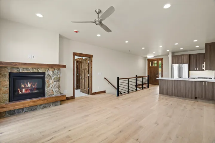 Open-concept living space featuring wide-plank wood-finish flooring, recessed ceiling lighting, and a ceiling fan
