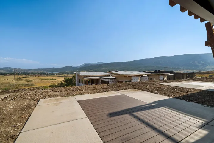 Outdoor patio featuring concrete pavers and wood-finish decking