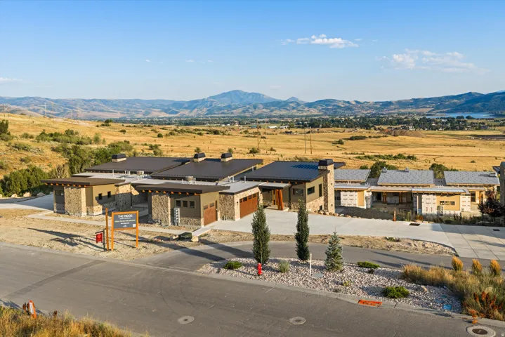 Modern architectural residence featuring a striking stone and wood-clad exterior with clean linear design