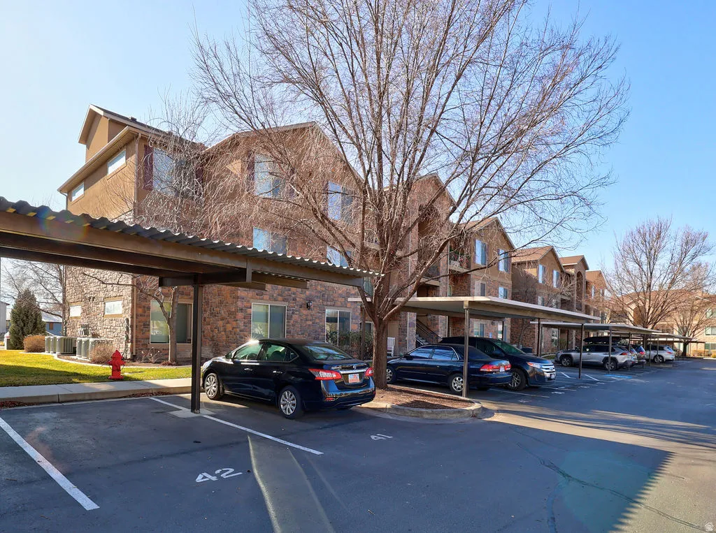 View of building exterior with covered parking