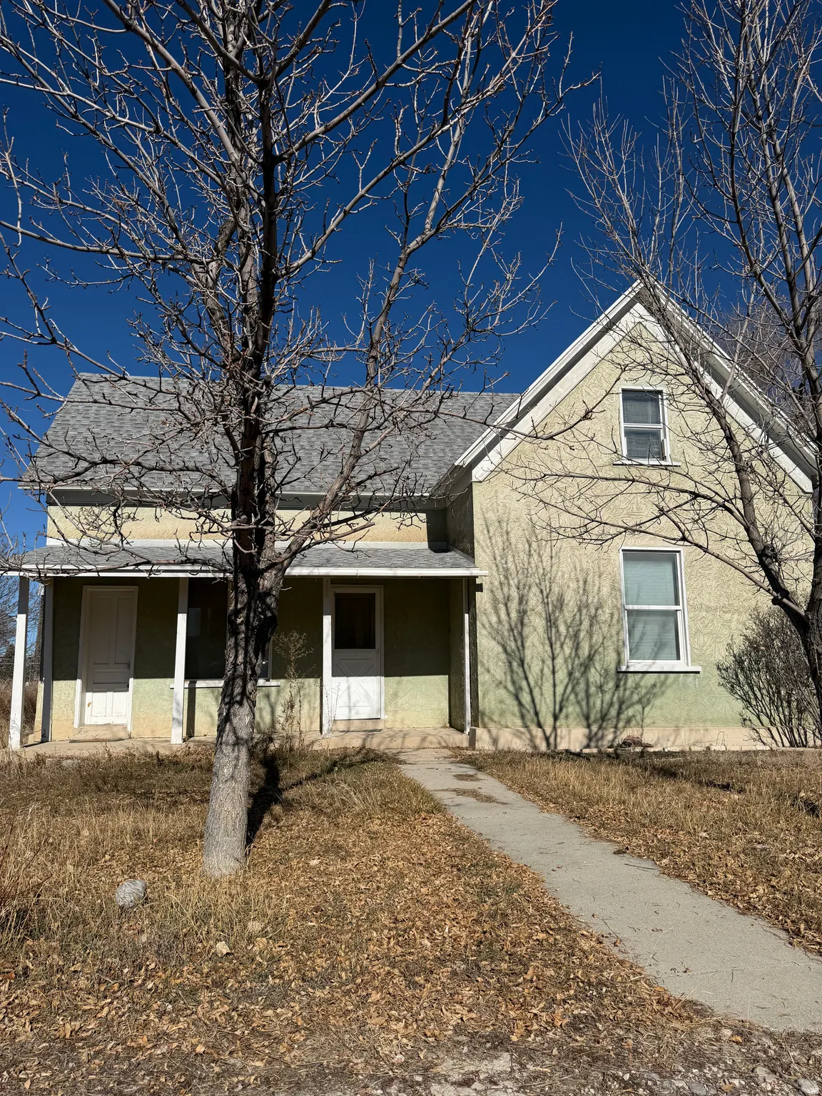 View of front of house with stucco siding and a porch